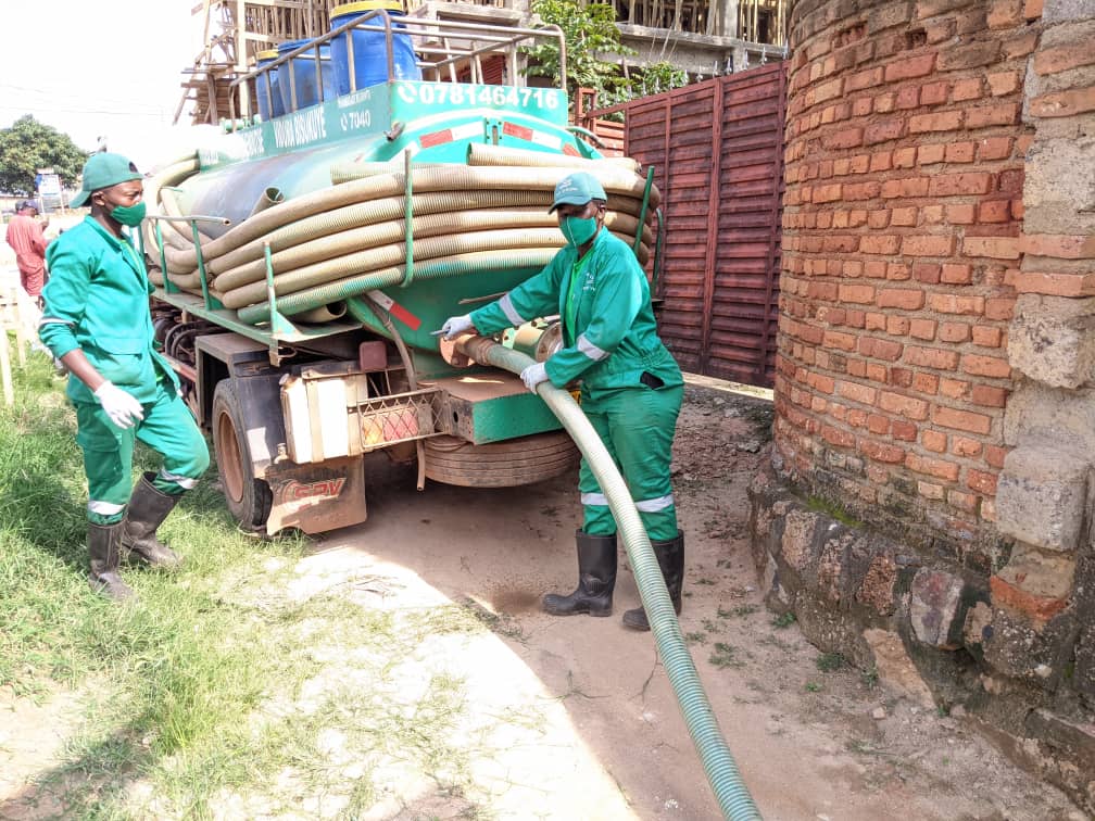 Female and male sanitation workers using exhauster truck in Kampala, contributing towards safely managed sanitation services (© Pit Vidura)